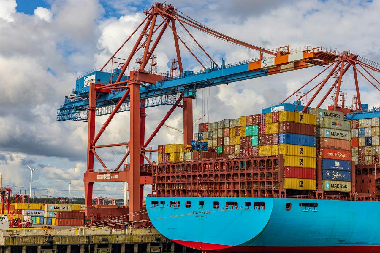 A container ship loaded with stacked containers in port
