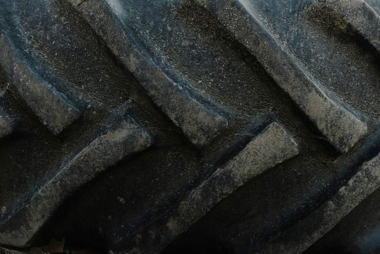 Close-up of the deep lugged tread on a large tractor tyre